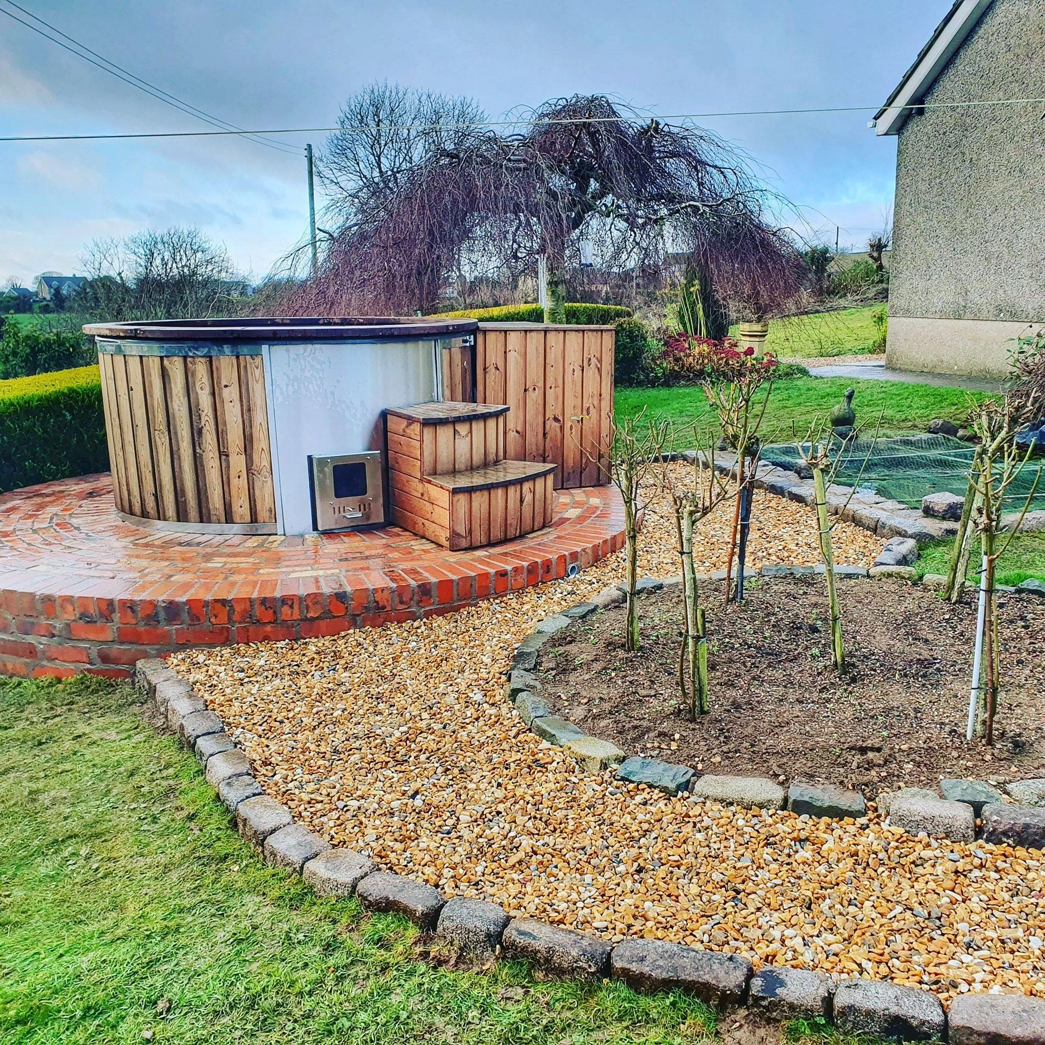 Garden landscaping with wooden hot tub surround